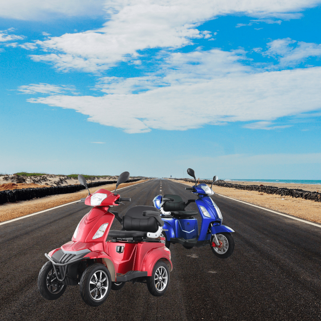 Two Nebula mobility scooters, one red and one blue, parked on a coastal road with clear blue skies and the ocean on the horizon.