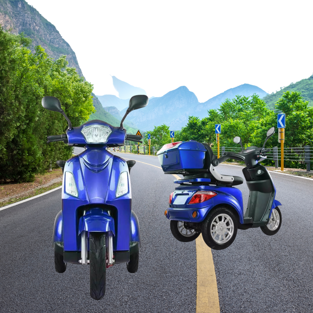 Two Comet electric scooters, one blue and one silver, parked on a road with a scenic mountain background and greenery on either side.