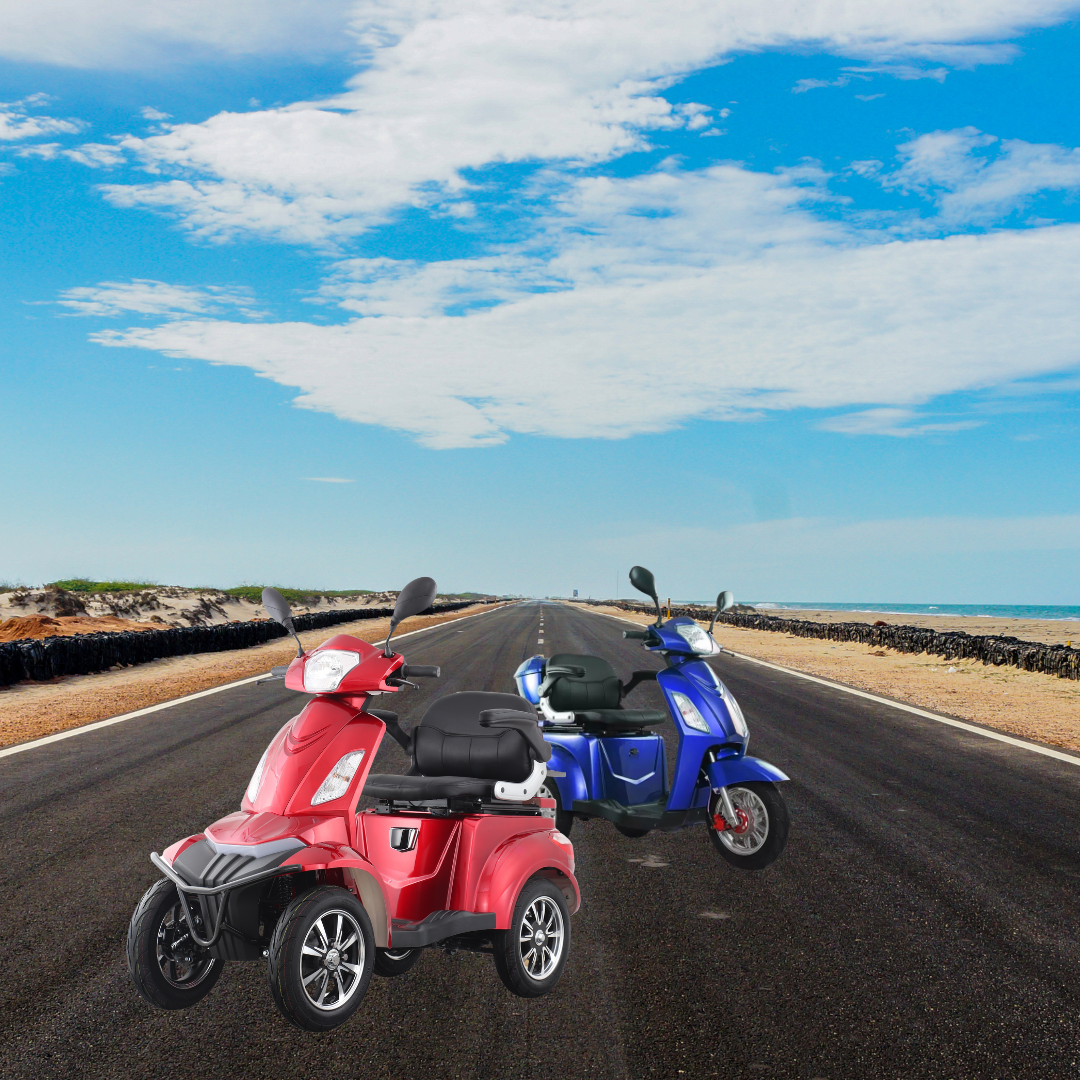 Two colorful Eclipse EV Comet electric scooters, one red and one blue, parked side by side on a coastal road, with clear skies above and the sea beside them.